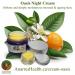 Oasis Night Cream in a blue jar with orange blossoms, fruit and leaves