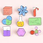 A collage of enamel pins chemistry theme