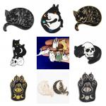 A collage of enamel pins of cats