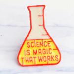 Enamel pin of a beaker says Science is Magic That Works